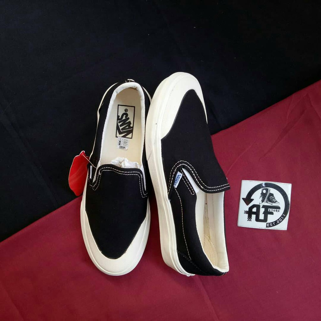 Half black half white slip best sale on vans