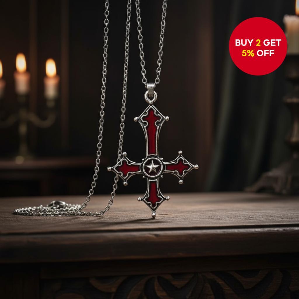 A statement necklace featuring a gothic punk reverse cross pendant in ...
