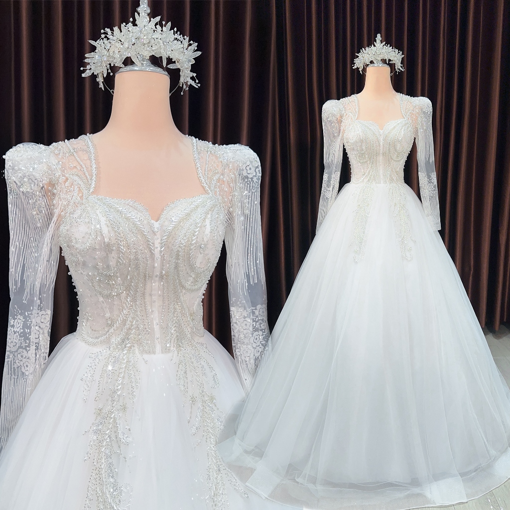 Aline longsleeved soft white wedding dress covers the shoulders for the bride to wear a simple